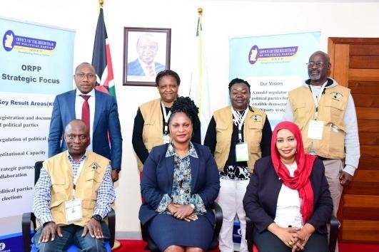 Registrar (center), Assistant registrar, Ali A. Surraw (back right) pose for a group photo with Officials of ZESN