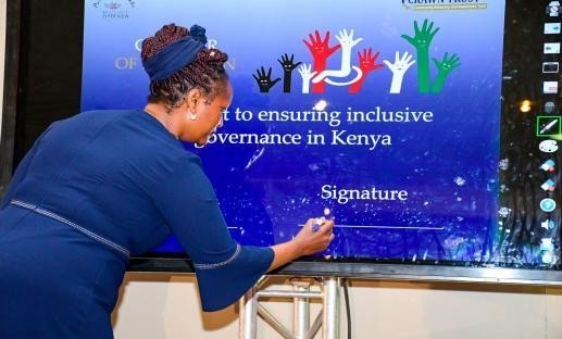 Registrar of Political Parties signs the inclusion Charter document at Desmond Tutu conference center, Westlands Nairobi.